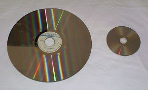 A laserdisc (left) compared with a DVD (right).