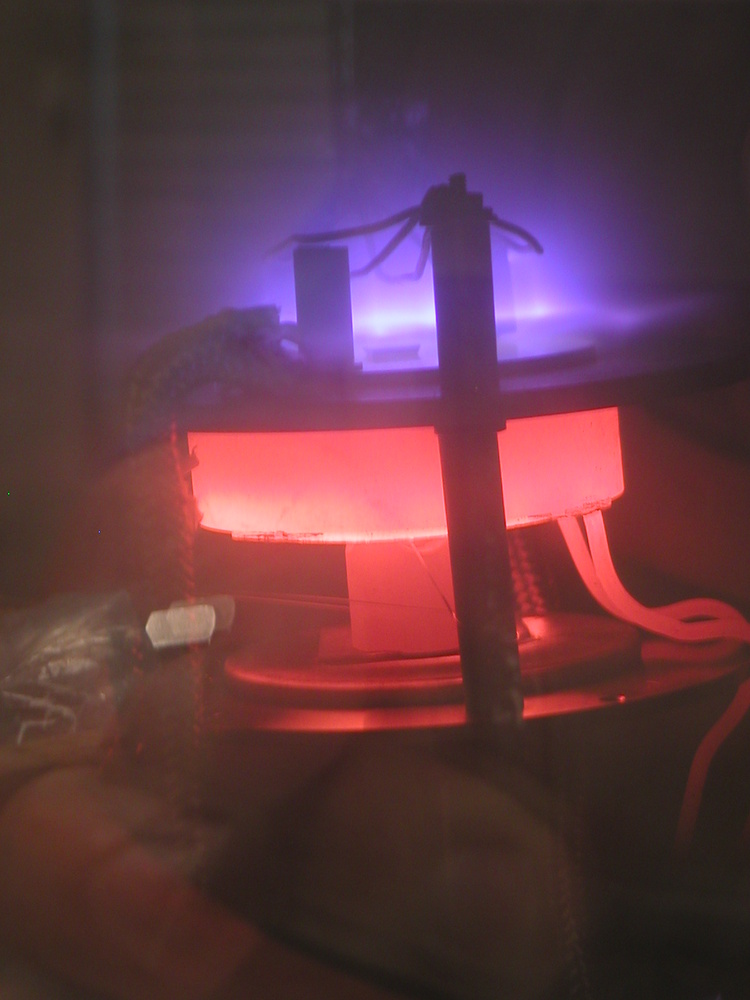 DC-PECVD system in action. DC plasma (violet) improves the growth conditions for carbon nanotubes in this chemical vapor deposition chamber. A heating element (red) provides the necessary substrate temperature.