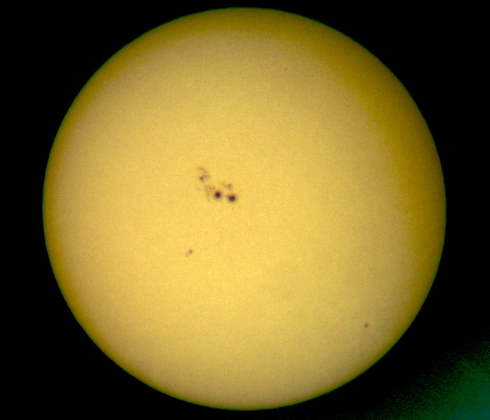 Ocular projection of the sun with large sunspots using a spotting scope (50mm diameter, 45x magnification) and a sheet of paper approx. 30 cm from the ocular. The apparent granulation is due to that of the paper rather than the photospheric...
