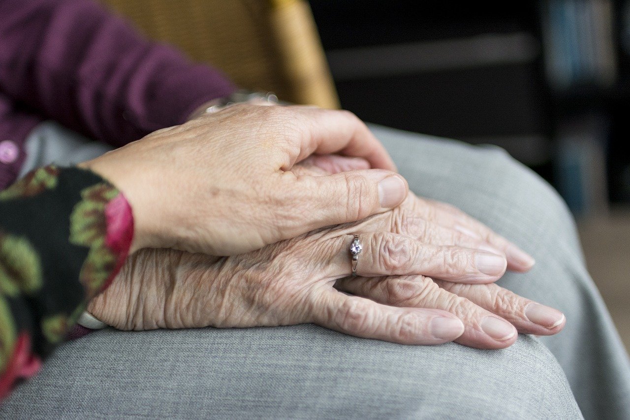 The hands of an elderly couple.