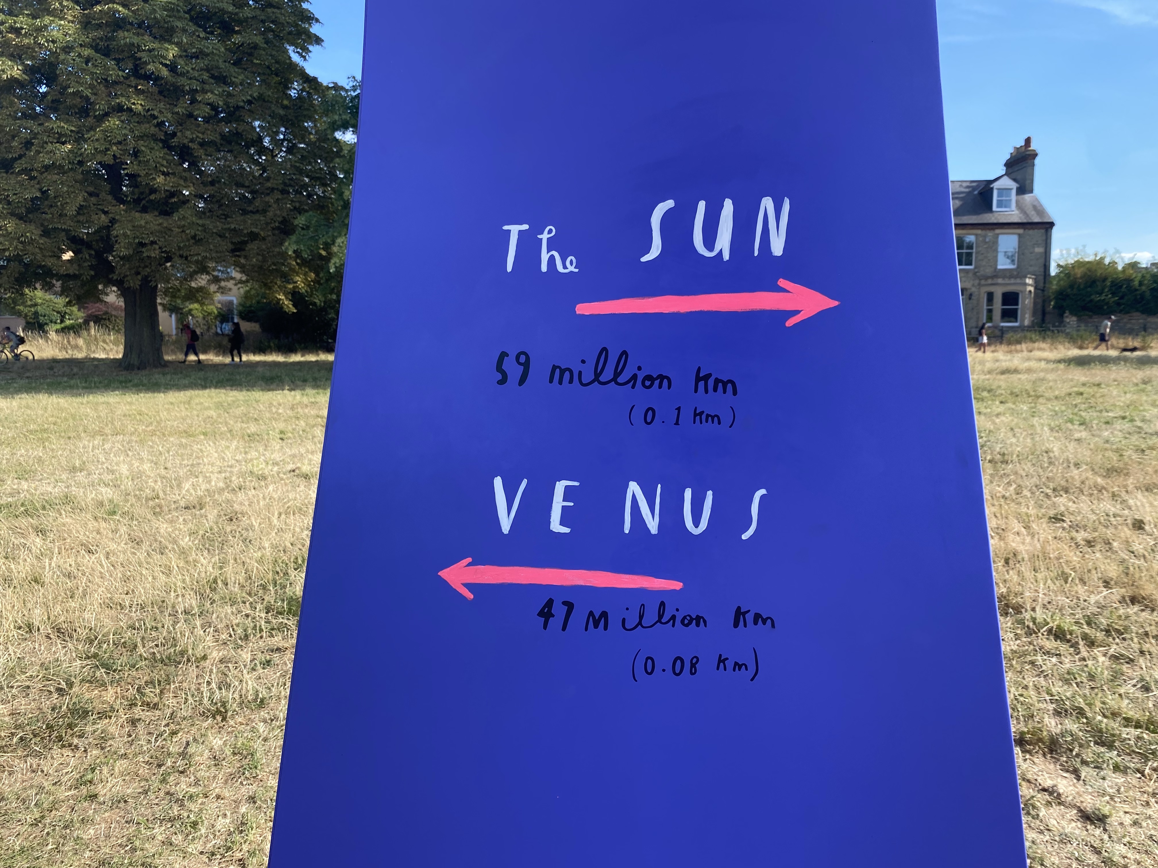 Purple sign saying the distance to the Sun and Venus on the 