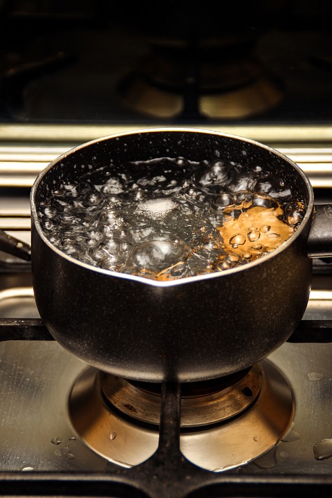 A pot of boiling water on a stove