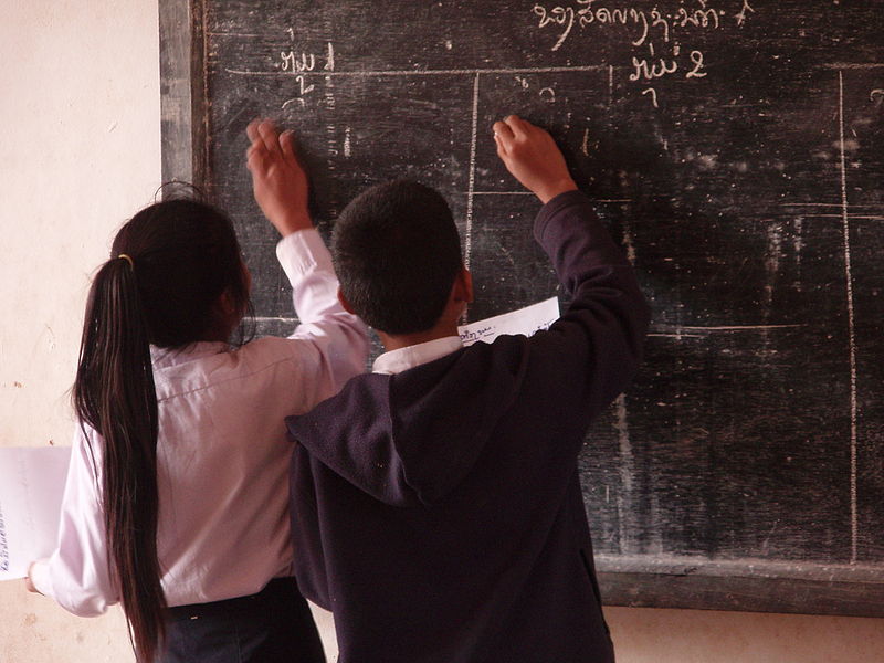 Schoolchildren writing on a blackboard