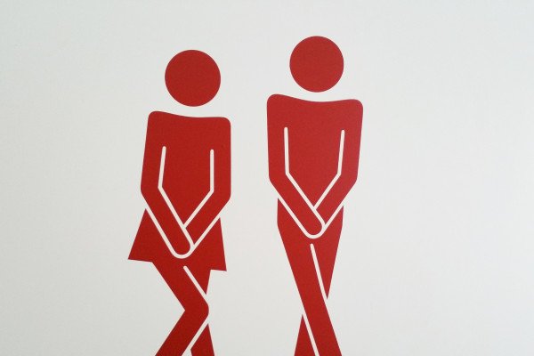 male and female stick people needing the toilet