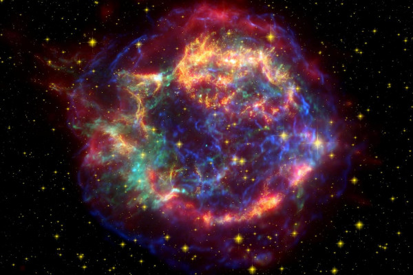 A false color image of Cassiopeia using observations from both the Hubble and Spitzer telescopes as well as the Chandra X-ray Observatory