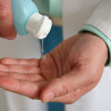 Using hand sanitiser to clean hands